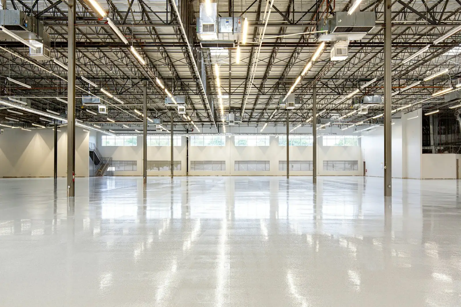 Empty modern warehouse with a polished concrete floor